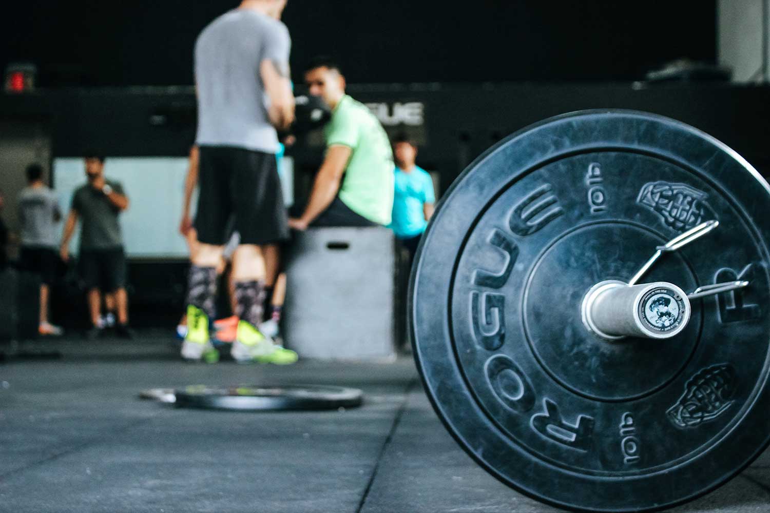 Men working out in a weightroom.
