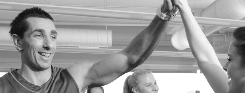 People giving high fives at at fitness bootcamp class