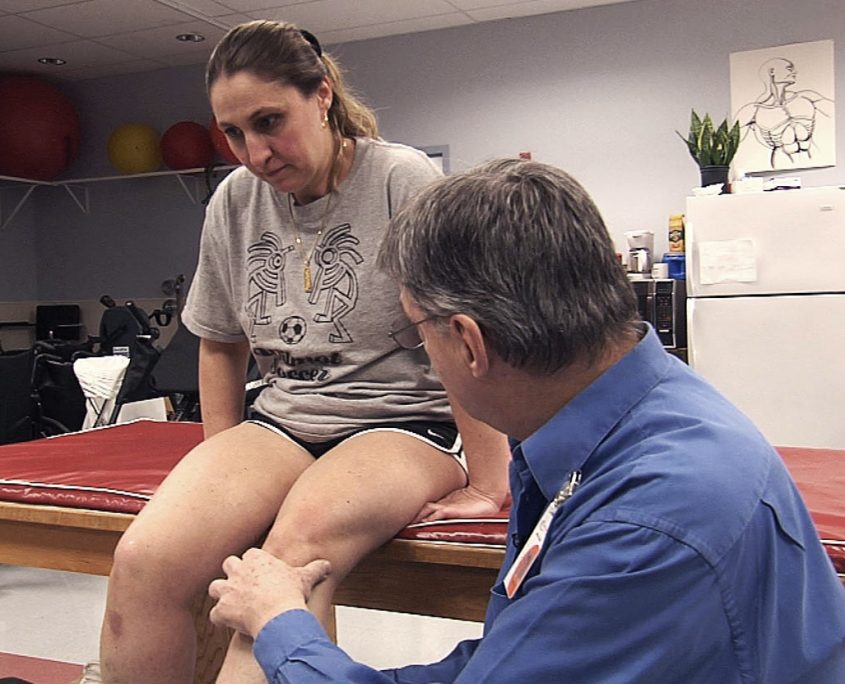 Physical Therapist talking to a patient.