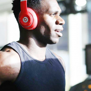 Man running on treadmill with headphones on listening to music