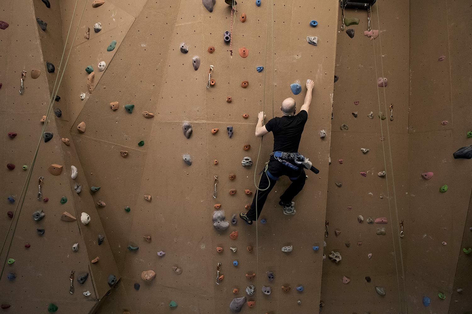 Man scaling a rock wall.