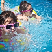 kids swimming in a outdoor pool