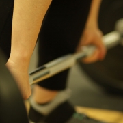 Woman weightlifting with heavy barbell