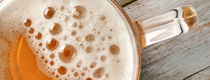 A beer on a wooden bench.