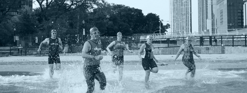 Trimonster participants running into Lake Michigan.