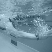 Side view of a woman swimming in a pool.