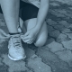 Runner tying shoelaces.