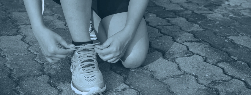 Runner tying shoelaces.
