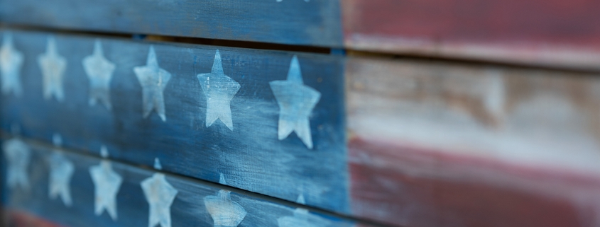 Texture of american flag painted over woodboard