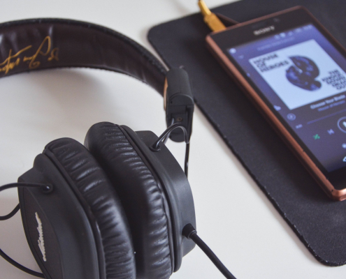 Headphones and iPhone playing a playlist