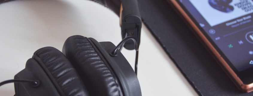 Headphones and iPhone playing a playlist