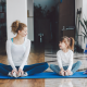 Woman and girl sitting together in yoga studio