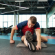 Man stretching on gym floor