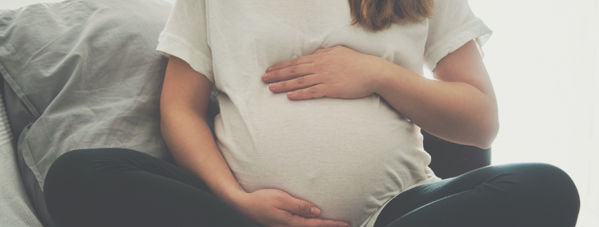 Pregnant woman touching her belly