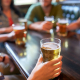 friends drinking beer and at bar or pub