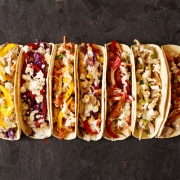 Varied traditional mexican corn tacos flat lay composition.