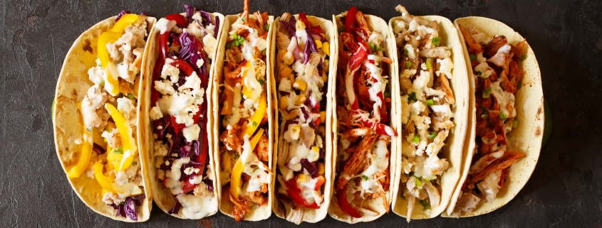 Varied traditional mexican corn tacos flat lay composition.