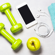 Dumbbells, measuring tape, water and smartphone top view. Fitness concept and healthy lifestyle.