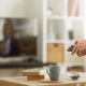 Person holding a remote and pointing it at a television