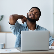 Golf ball on tee with blue sky above