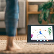 woman with ipad watching yoga class at home
