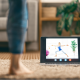 woman with ipad watching yoga class at home