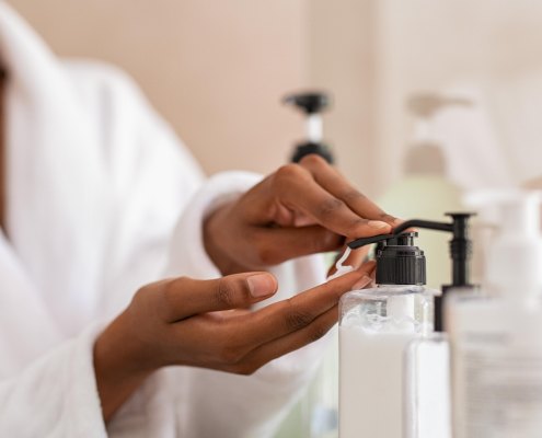 Woman using body lotion dispenser