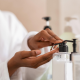 Woman using body lotion dispenser