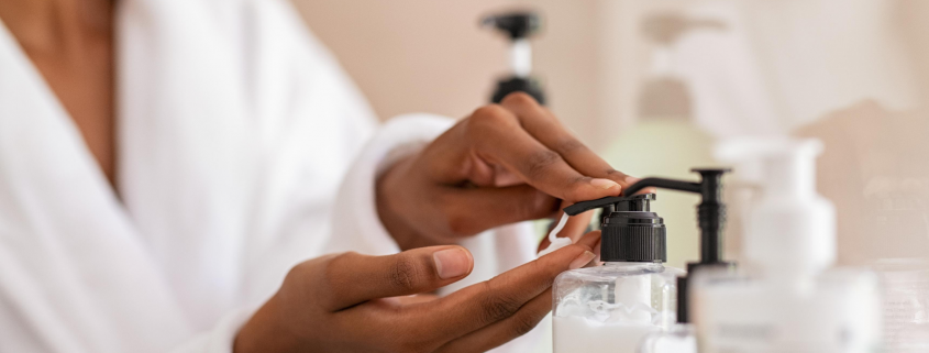 Woman using body lotion dispenser