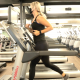 Woman running on treadmill wearing a mask