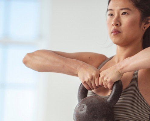 Woman lifting heavy kettlebell