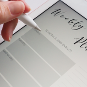 Photo of a hand hovering over an electronic weekly planner