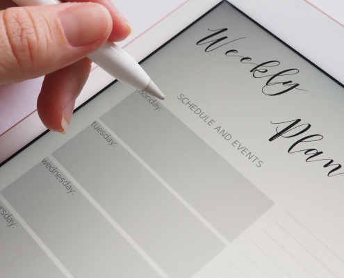 Photo of a hand hovering over an electronic weekly planner