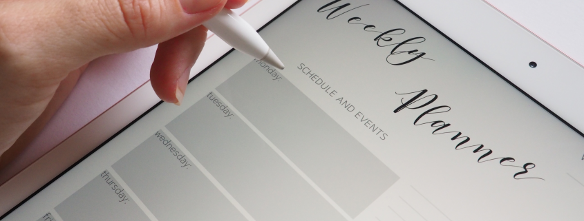 Photo of a hand hovering over an electronic weekly planner