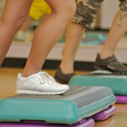 Image of a woman stepping onto an aerobics step