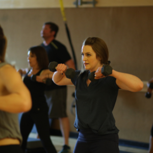 Woman lifting weights in a #312 group fitness class in Chicago