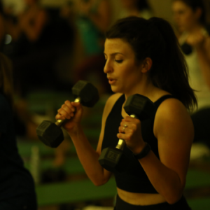 Woman lifting weights in an Endura94 group fitness class in Chicago