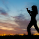 Outline of a woman at sunset with fists up in fighting stance