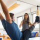 Woman instructing a man on the Pilates apparatus