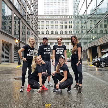 Group for 6 people in black shirts standing in the street