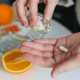 Person with a dietary supplement pill in their hand.