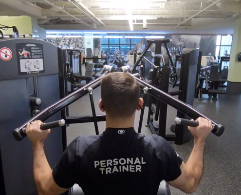 FFC Personal Trainer using lat pulldown weight machine at the gym