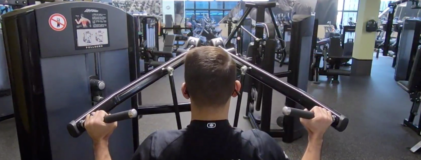 FFC Personal Trainer using lat pulldown weight machine at the gym