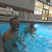 Juan smiling in pool with trainer Joy