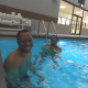 Juan smiling in pool with trainer Joy