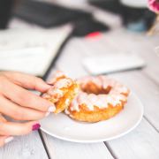 Photo of a hand reaching for a donut