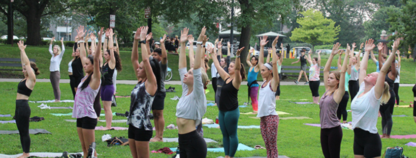 People in mountain pose in an outdoor yoga class