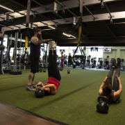 People exercising on turf at indoor gym