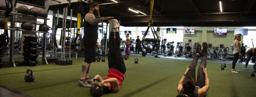 People exercising on turf at indoor gym
