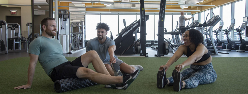 3 Friends Stretching On The Turf
